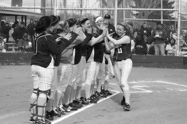 Junior Jenni Peer high-fives her teammates prior to the April 28 cross-town game.