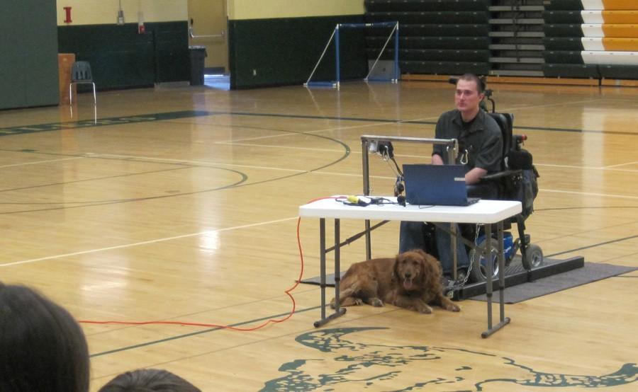 Mike Woods with his dog, Courage, during one of the assemblies on April 16.