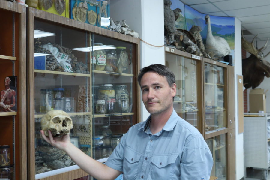 Nathan Gregier stands with skull. 