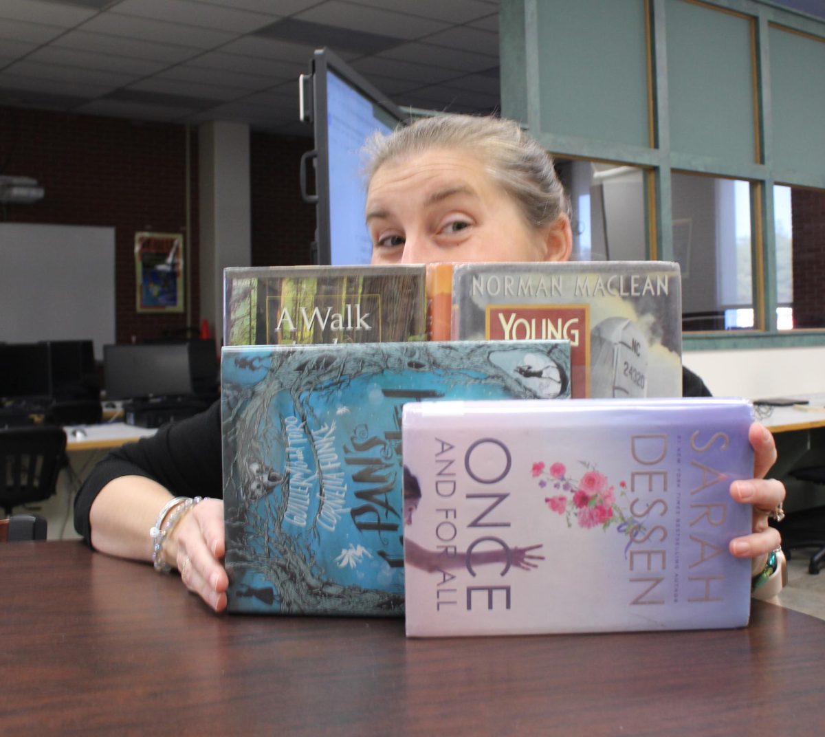 English teacher Kate Ott strikes a literary pose in the CMR library.