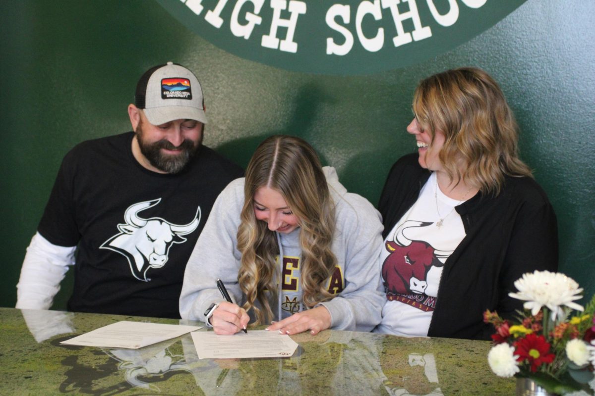 Senior Georgia Hatzenbeller, pictured here with her parents, signs to swim for the Mavericks at Colorado Mesa University in Grand Junction, Colo.