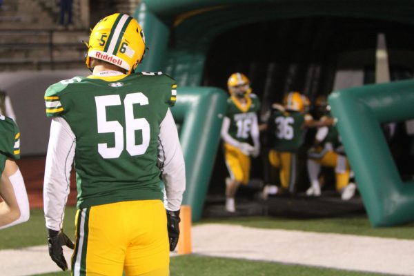 Cody Hoehn (56) prepares to welcome the starters to the field on Oct. 25 as the Rustlers, under coach AJ Wilson, take on Great Falls High.