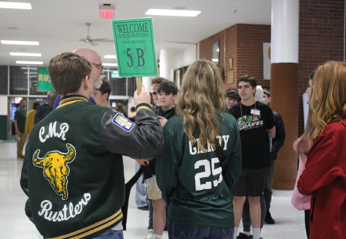 Senior role models Kaydence Gilroy and Jack Orthman guide their group of incoming freshmen throughout the halls of CMR.