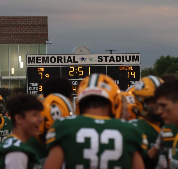 With the score reading 14-7, the CMR football team puts their heads together to re-strategize.