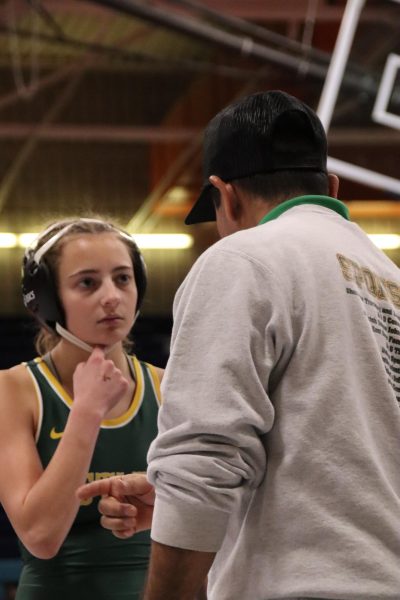 Senior Madelyn Osterman receives coach feedback after her first match-up on Dec. 19th.